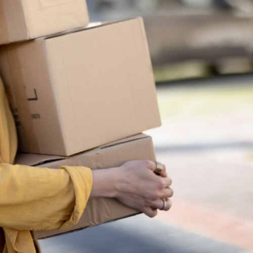 Woman carrying cardboard boxes